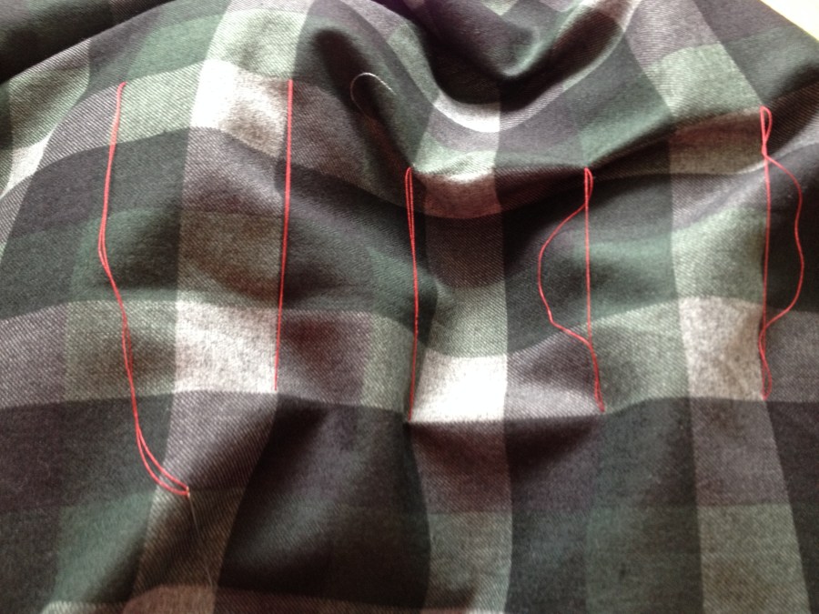 Basting the two layers of plaid together to keep everything straight.